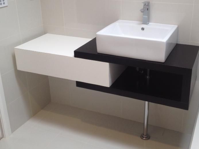 A Bathroom Sink With a Black and White Counter Top — Craig Allman Construction Pty Ltd In Fernhill, NSW