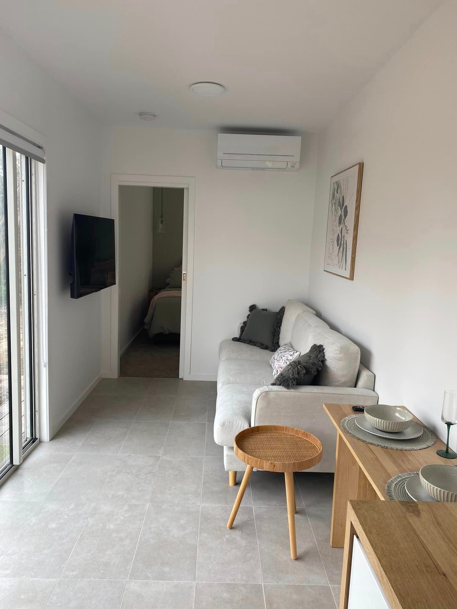 Living Room With A Couch Table And Television — GTH Living In Ocean Grove, VIC