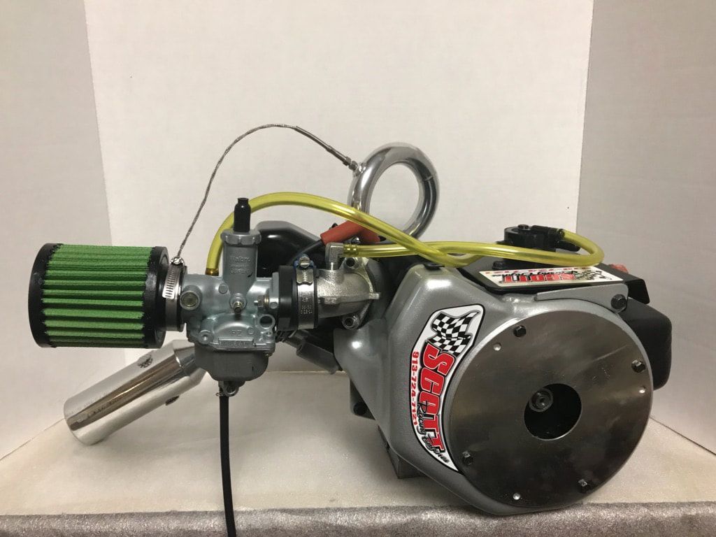 A small engine with a green filter attached to it