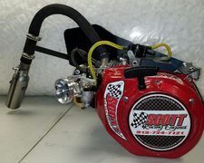 A red engine with a hose attached to it is sitting on a table.