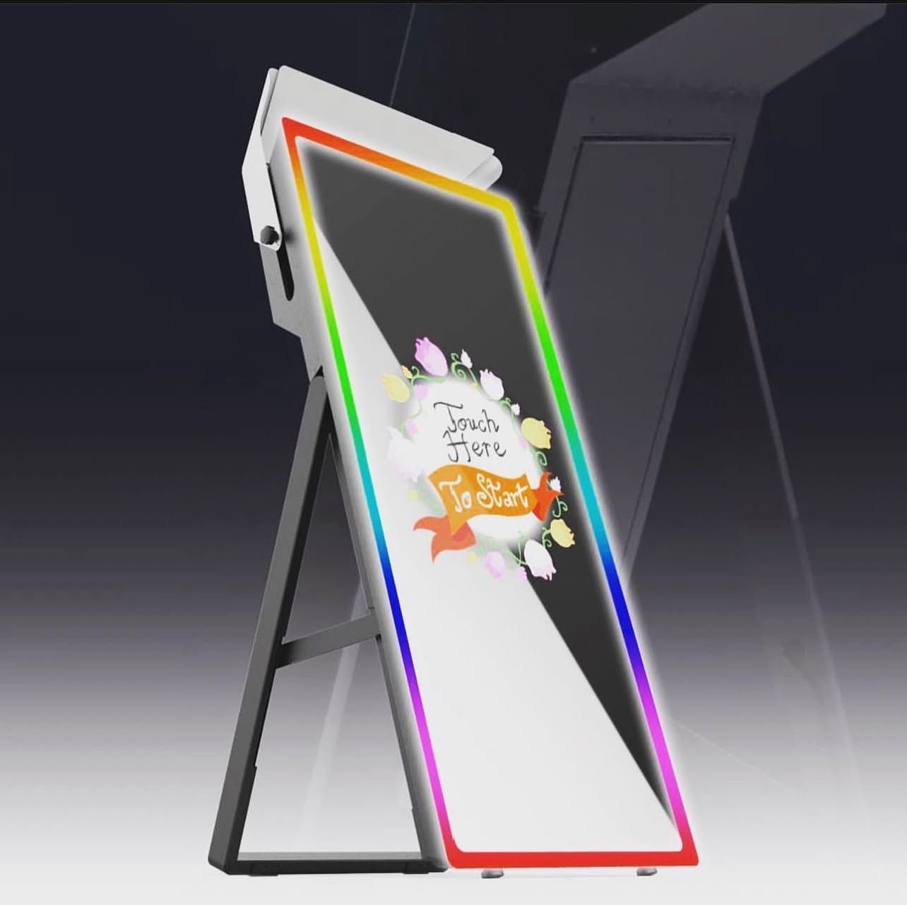 Glowing neon-edged digital display on a black stand, angled in a dark showroom.