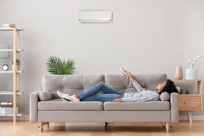 Girl Holding Air Conditioner Remote — Jacksonville, FL — Willman Air Girl Holding Air Conditioner Remote — Jacksonville, FL — Willman Air