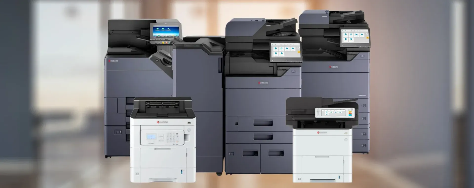 Three large gray office copiers/printers displayed side by side, with control panels visible.