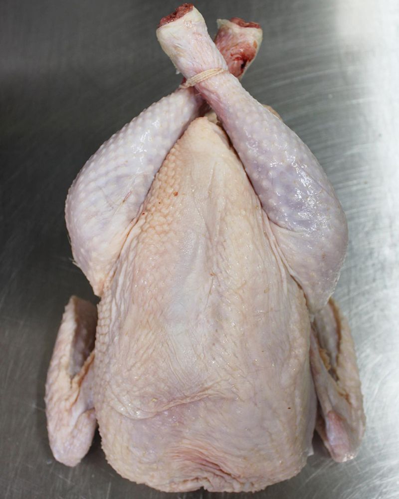 A Raw Chicken on a Stainless-steel Surface — Nambour Heights Butchery in Nambour, QLD