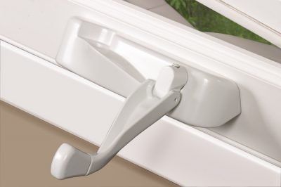 White window crank handle on a white window frame, indoors.