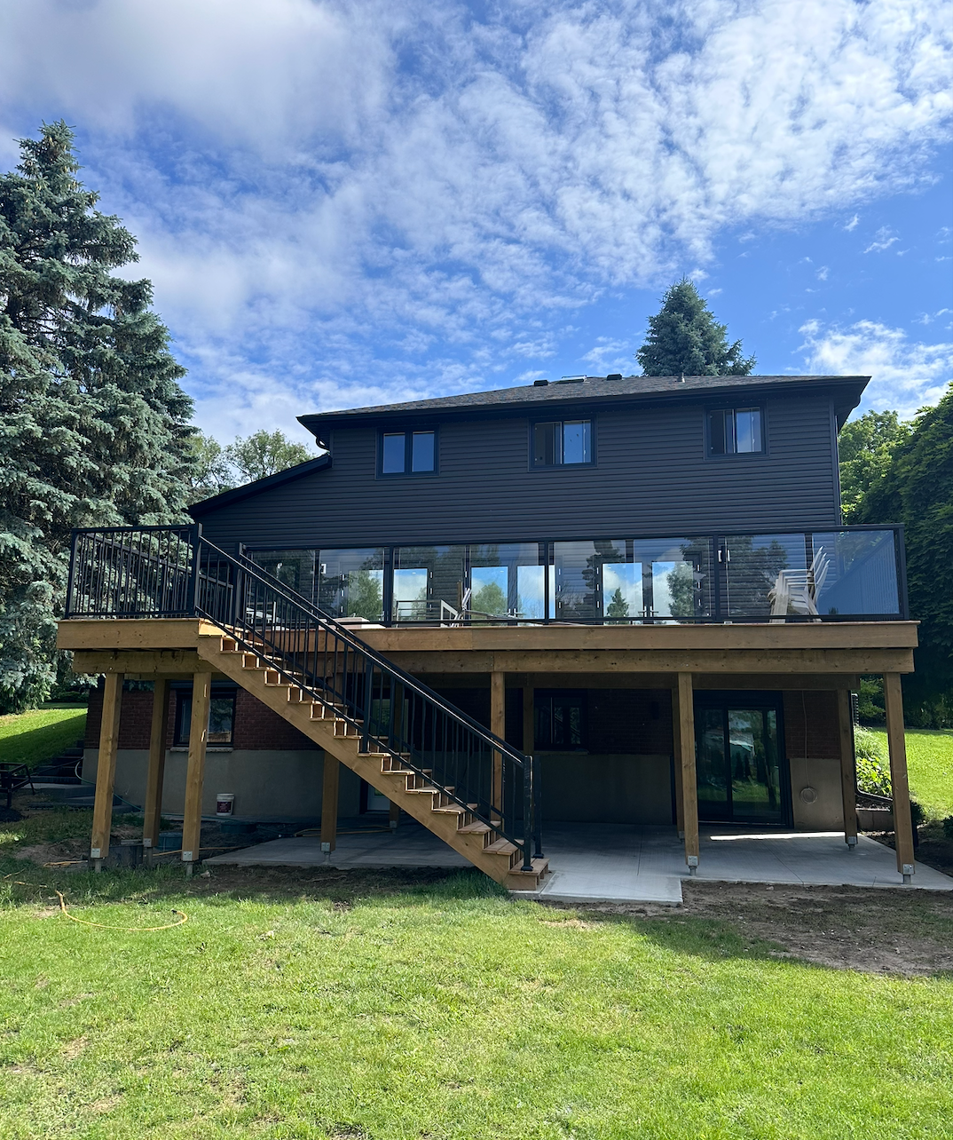 Glass Railings and Elevated Wood Deck by MowGoSnowGo, Landscapers in Guelph 