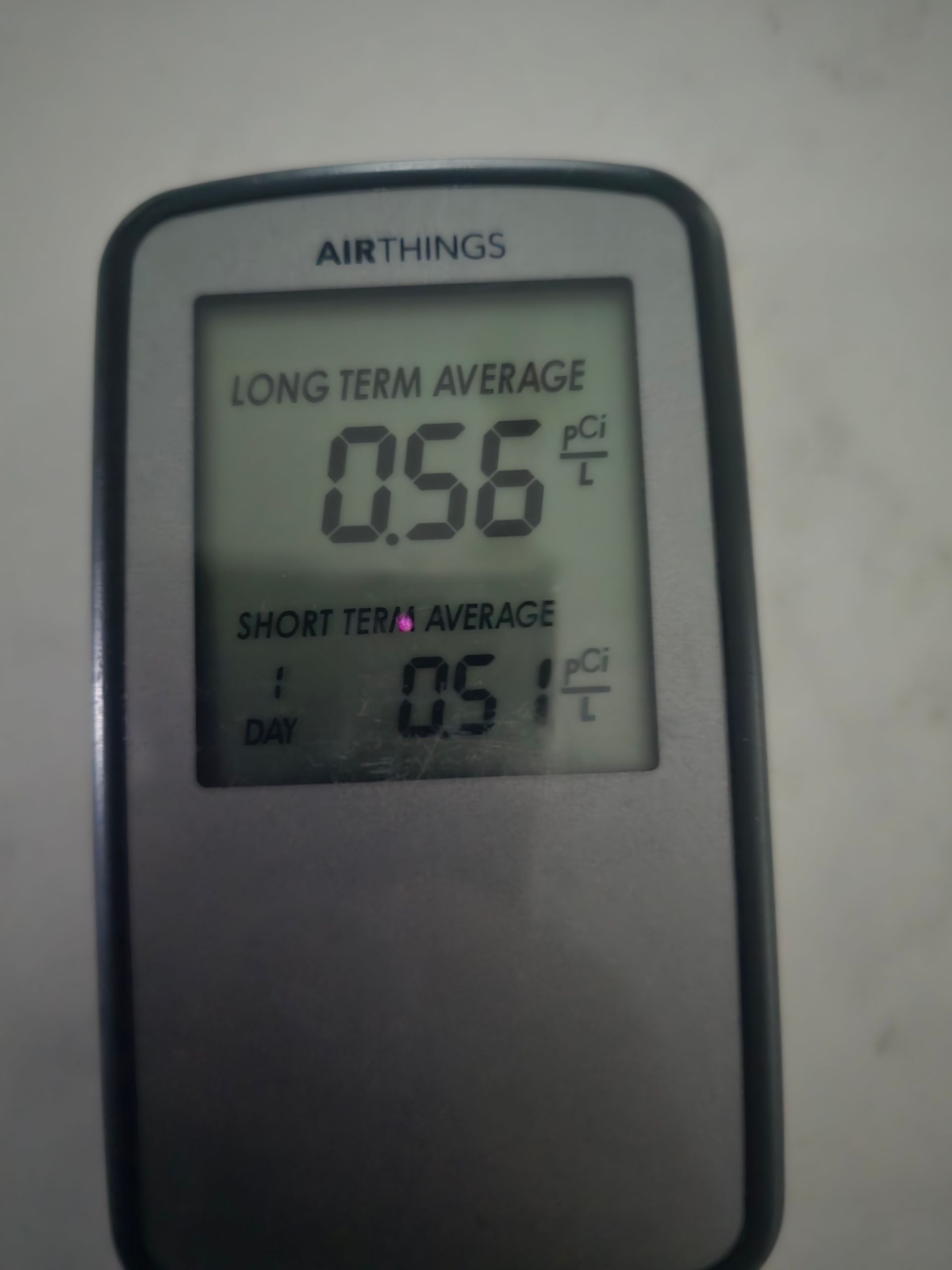 Airthings monitor displaying long-term average 0.56°F and short-term average 0.51°F.