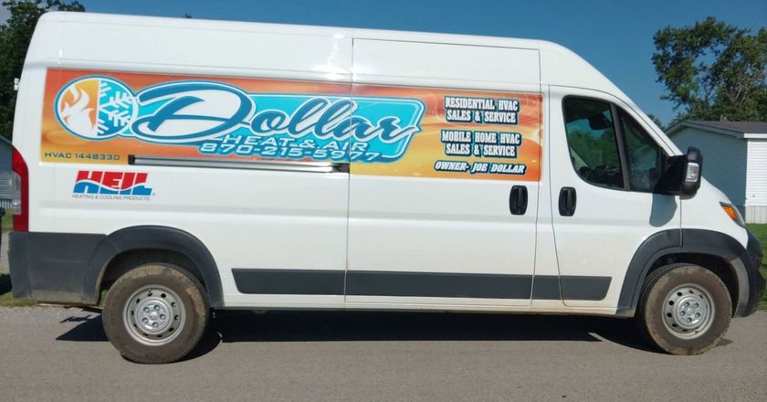 White delivery van with a large colorful “Dollar” advertisement on the side, parked outdoors.