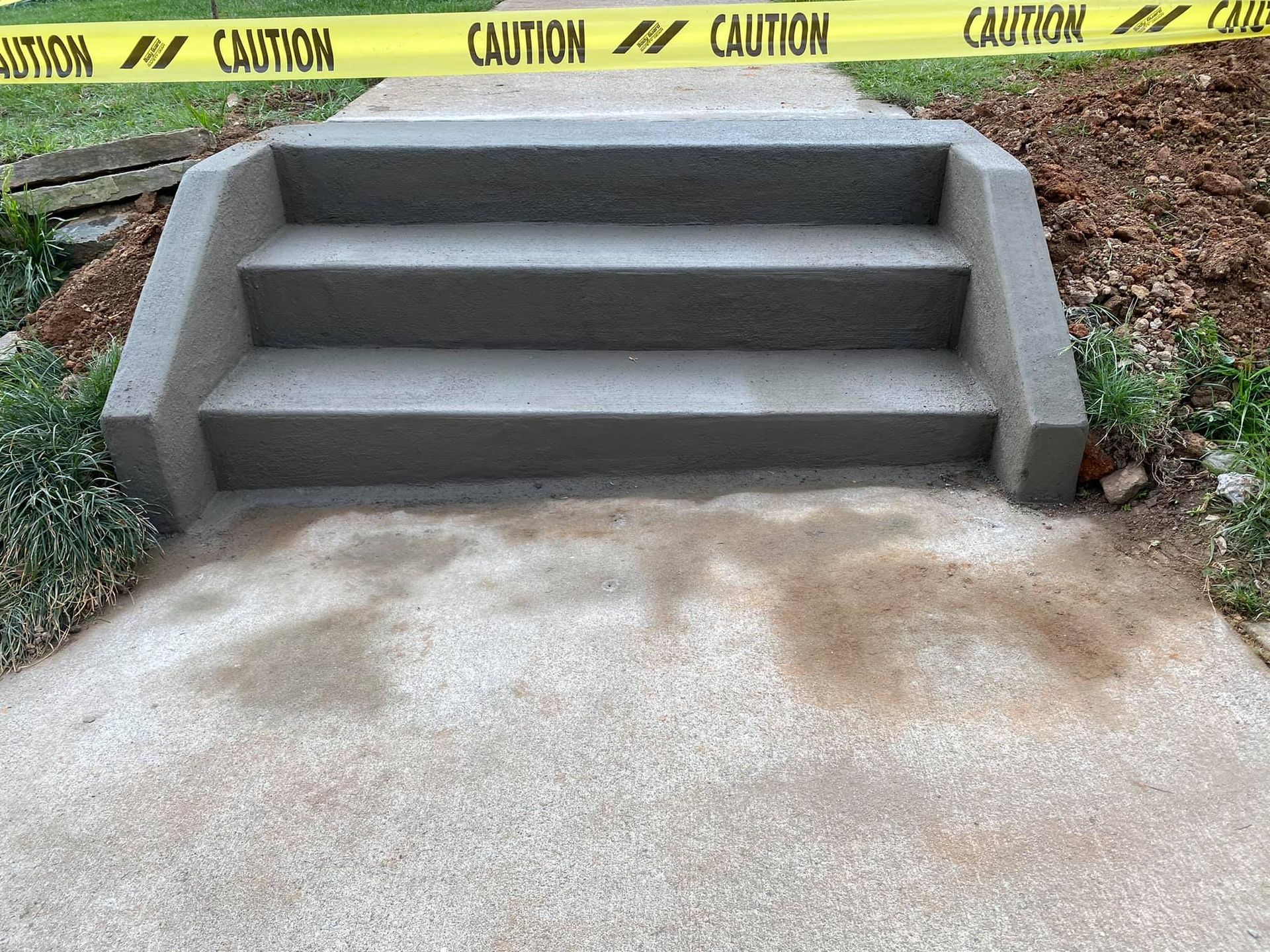 A set of stairs with a yellow caution tape around them.