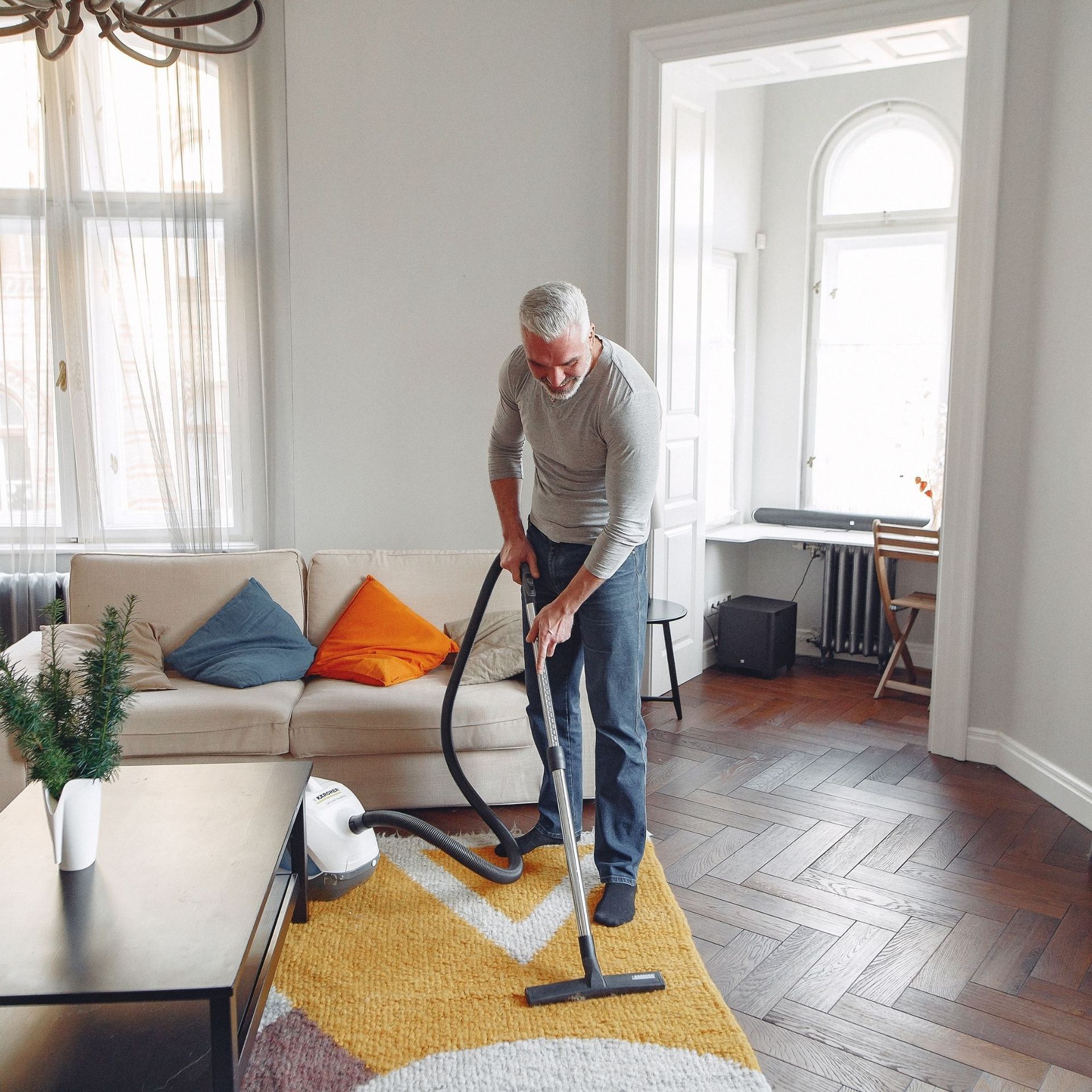 Arizona Carpet and Tile Steamers, Inc.- A person is using a steam cleaner to clean a carpet.