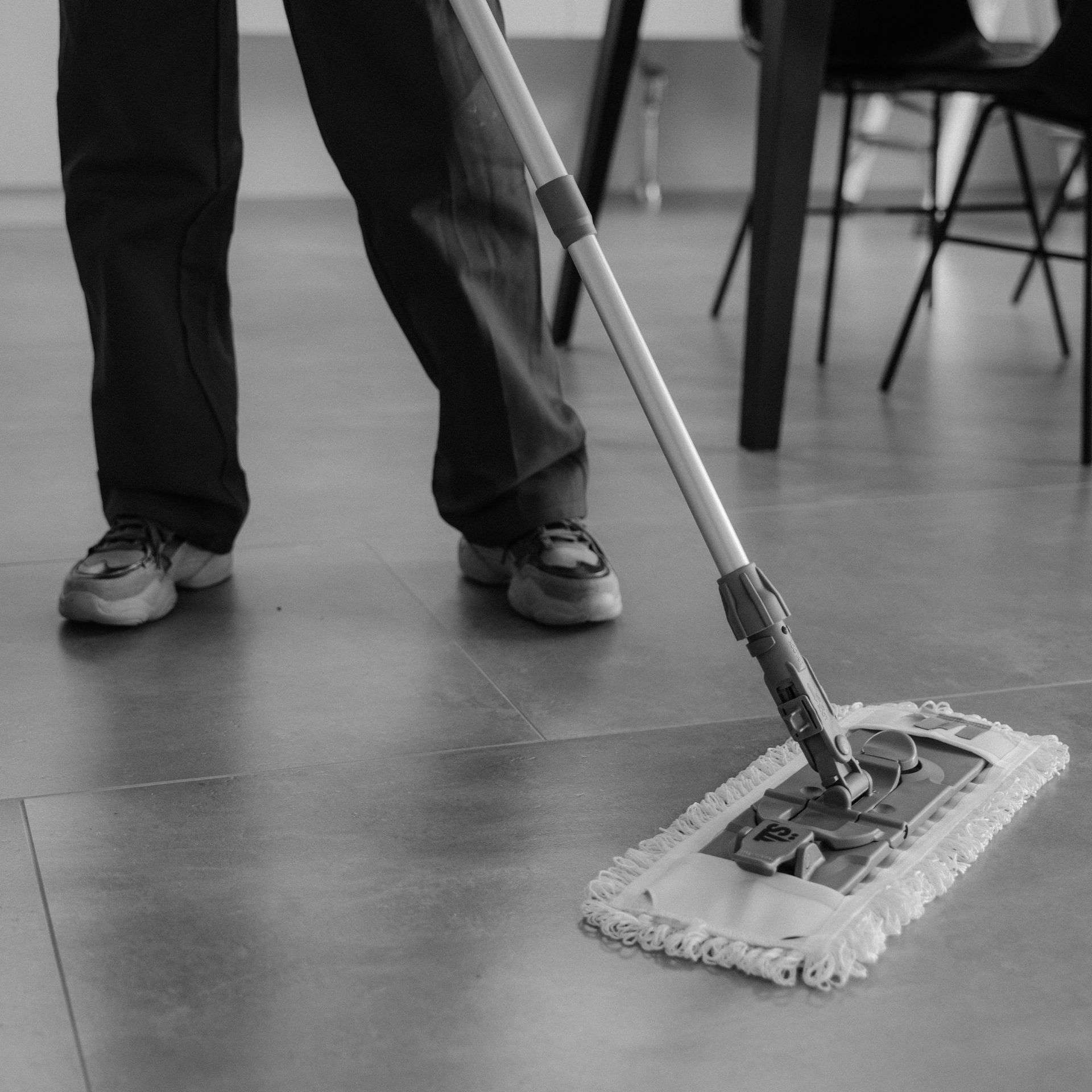 Arizona Carpet and Tile Steamers, Inc.- A person wearing orange gloves is cleaning a tile floor with a sponge.