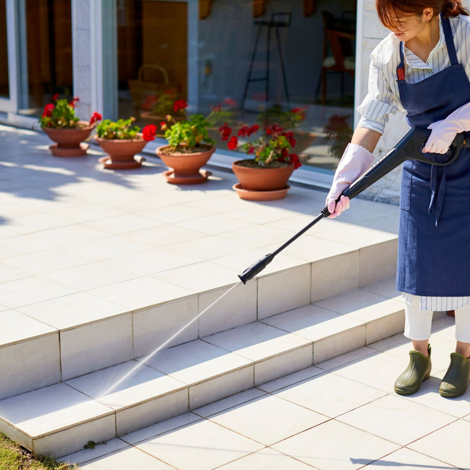 Arizona Carpet and Tile Steamers, Inc.- A person wearing orange gloves is cleaning a tile floor with a sponge.