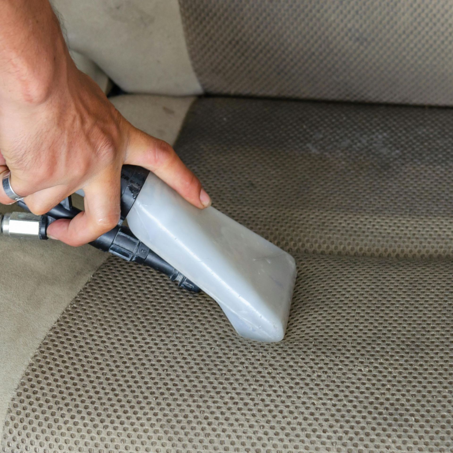Arizona Carpet and Tile Steamers, Inc.- A black and white photo of a vacuum cleaner cleaning a carpet.
