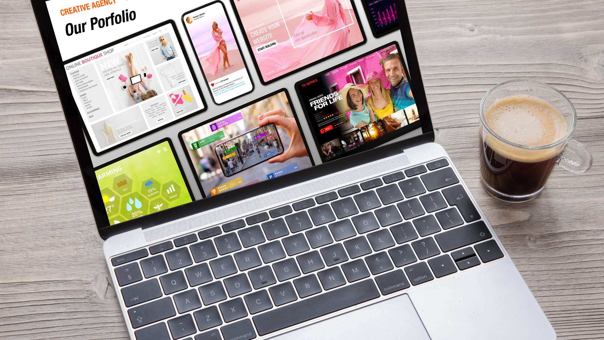 Laptop displaying a website with colorful images and text, next to a cup of coffee on a wooden surface.