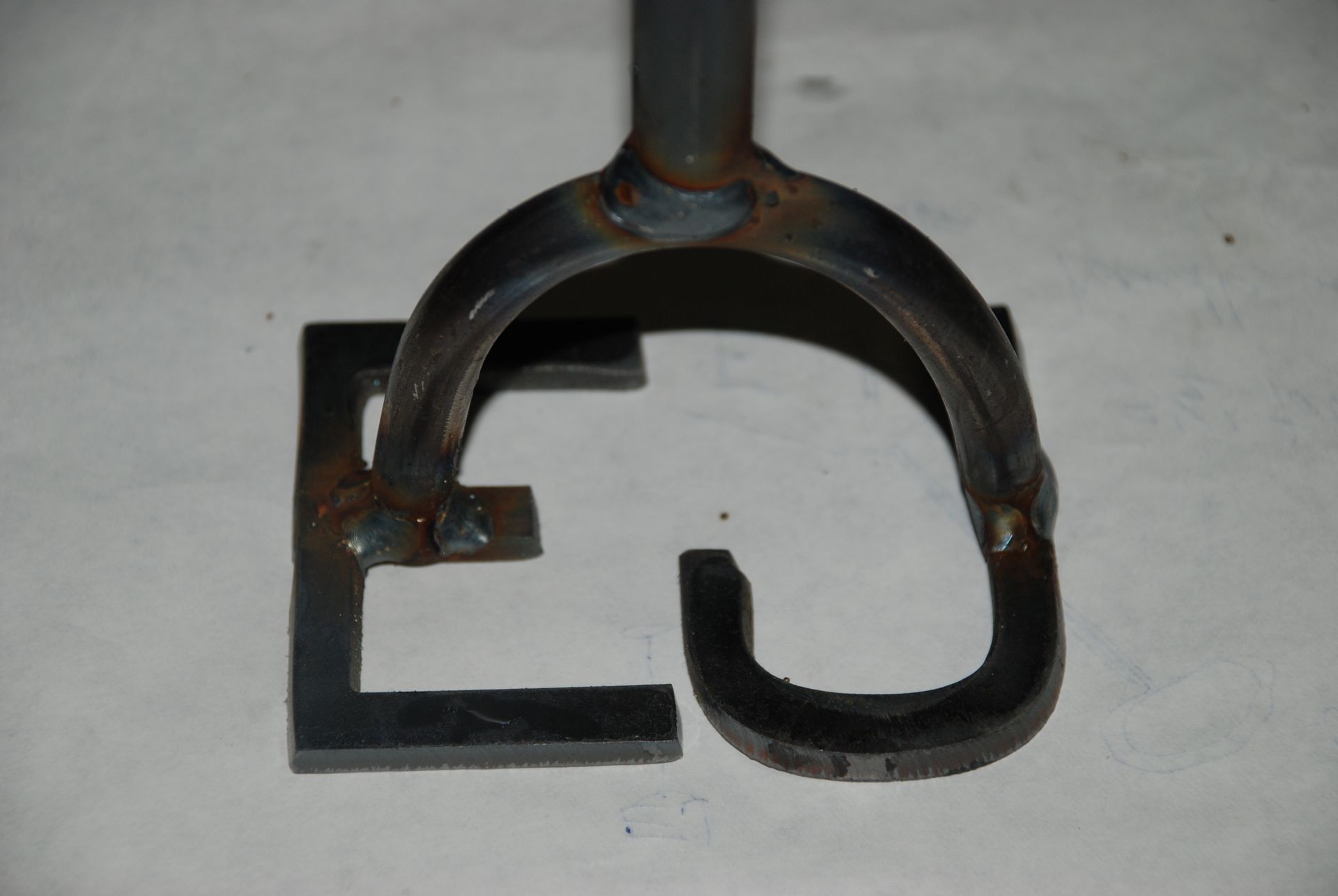 Metal branding iron with the letters 