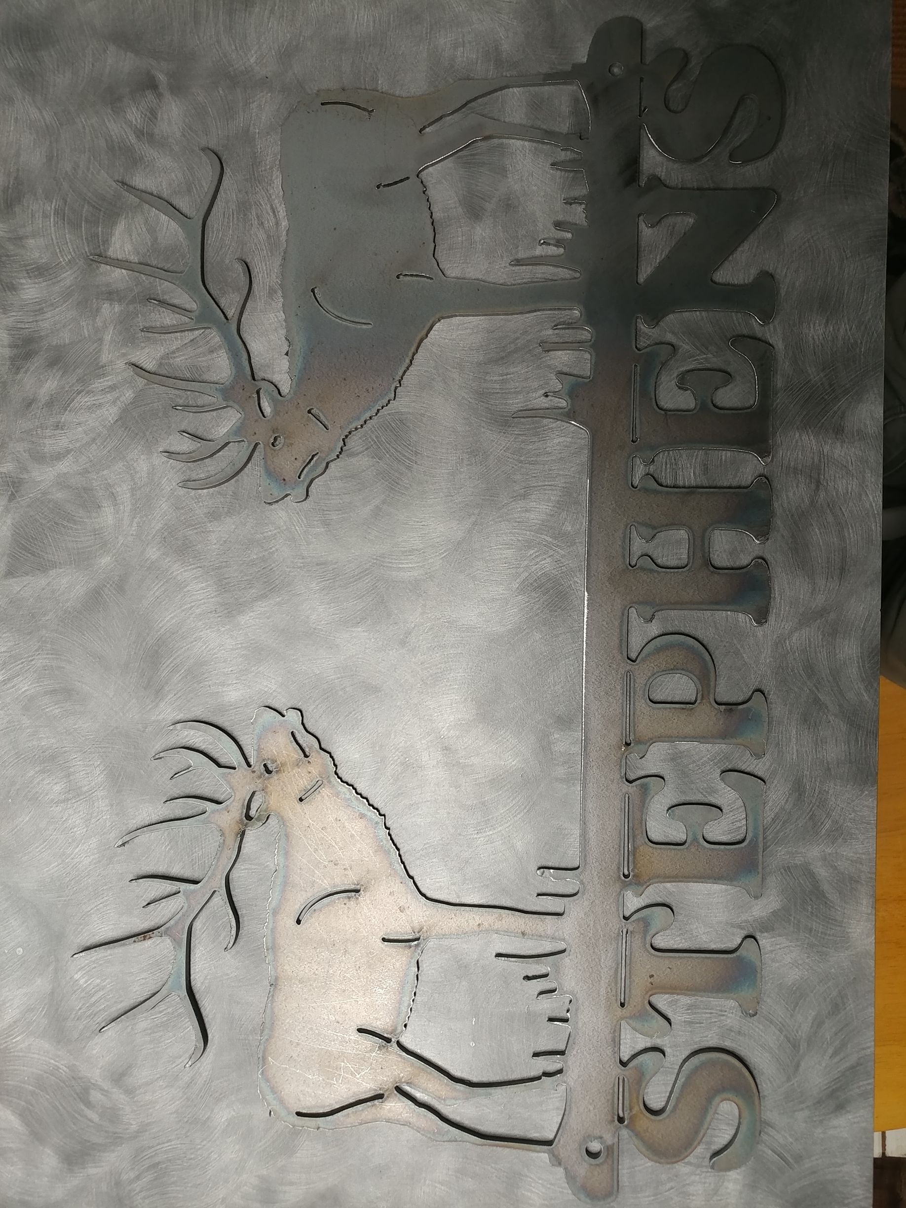 Metal sign with two deer and