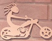 Wooden cutout of Kokopelli riding a motorcycle against a brick wall.