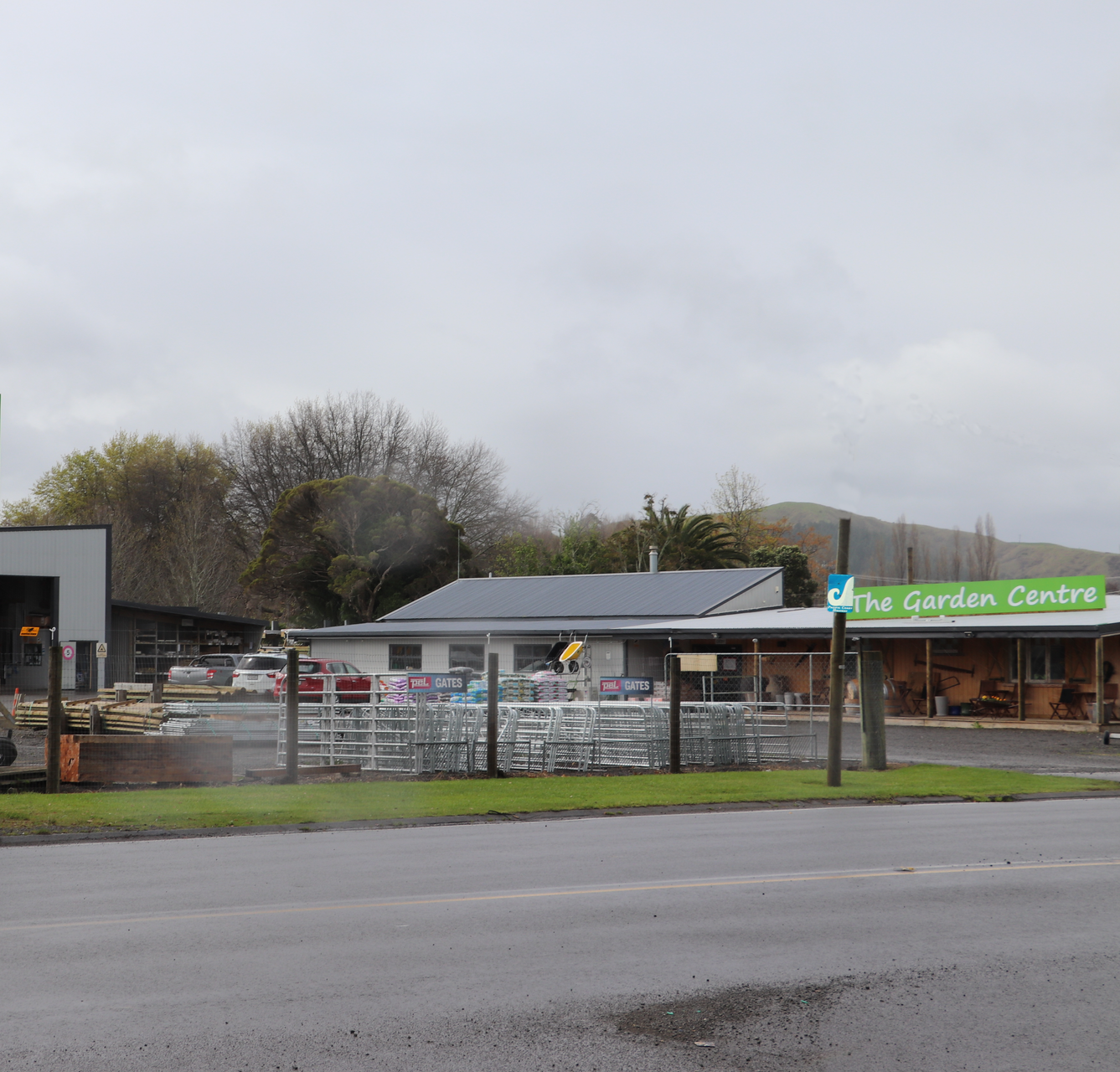An Eastland Farm Supplies store featuring a BuildLink sign, an outdoor yard, and a garden centre under a cloudy sky.