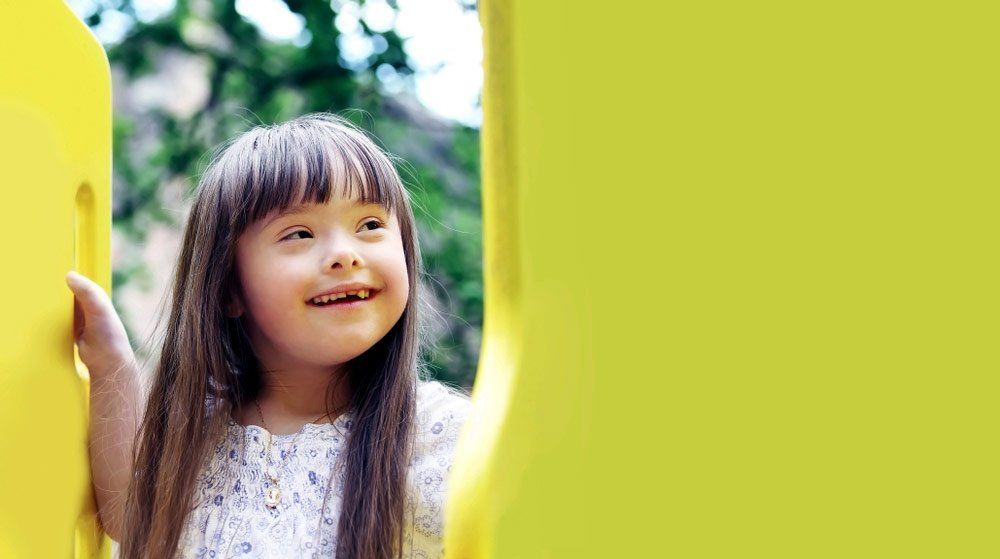 Smiling Young Girl On A Playground — Better Access Support Services In Gatton, QLD