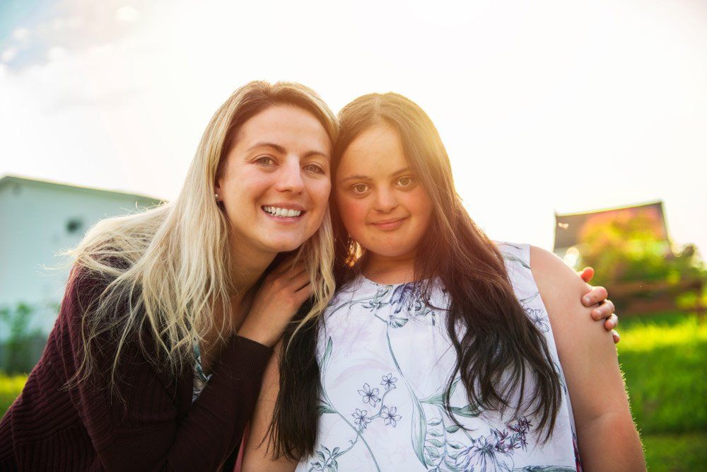 Two Girls Smiling At Sunset — Better Access Support Services In Wyreema, QLD