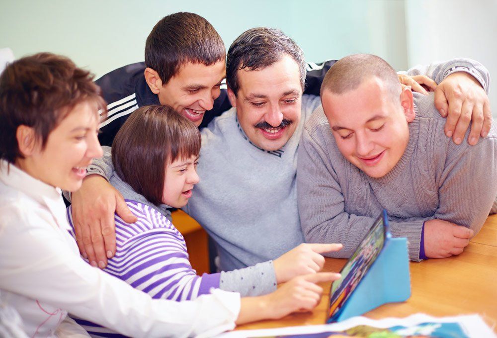 Group Of People Looking At A Photo — Better Access Support Services In Warwick, QLD