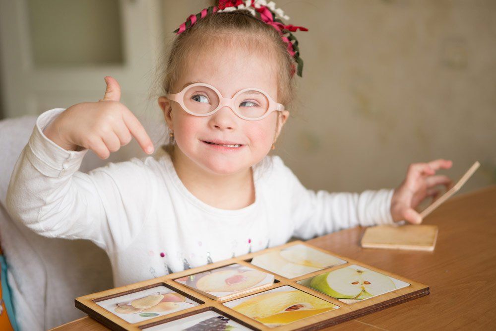 Young Girl Playing With a Wooden Puzzle — Better Access Support Services In Gatton, QLD