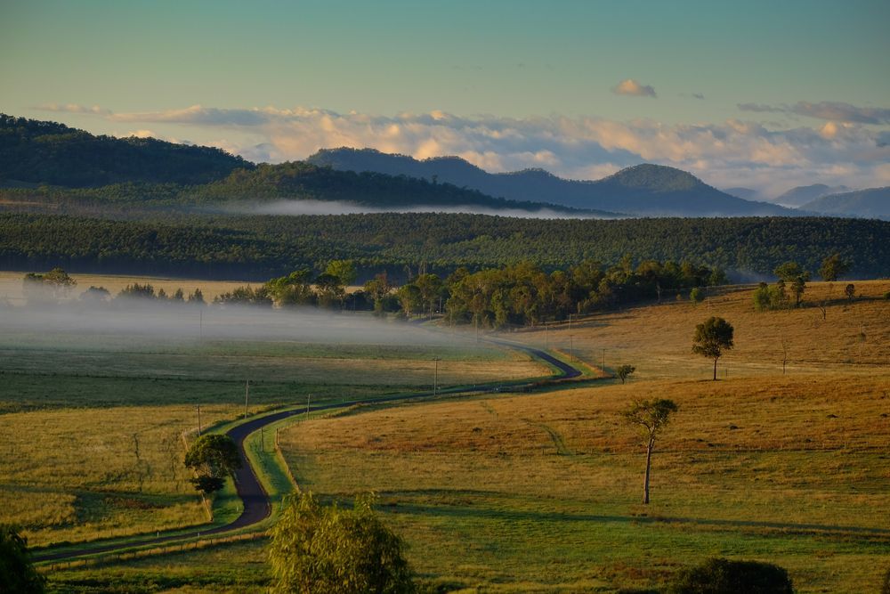 A Foggy Landscape With a Road Going Through It — Better Access Support Services In Ipswich, QLD