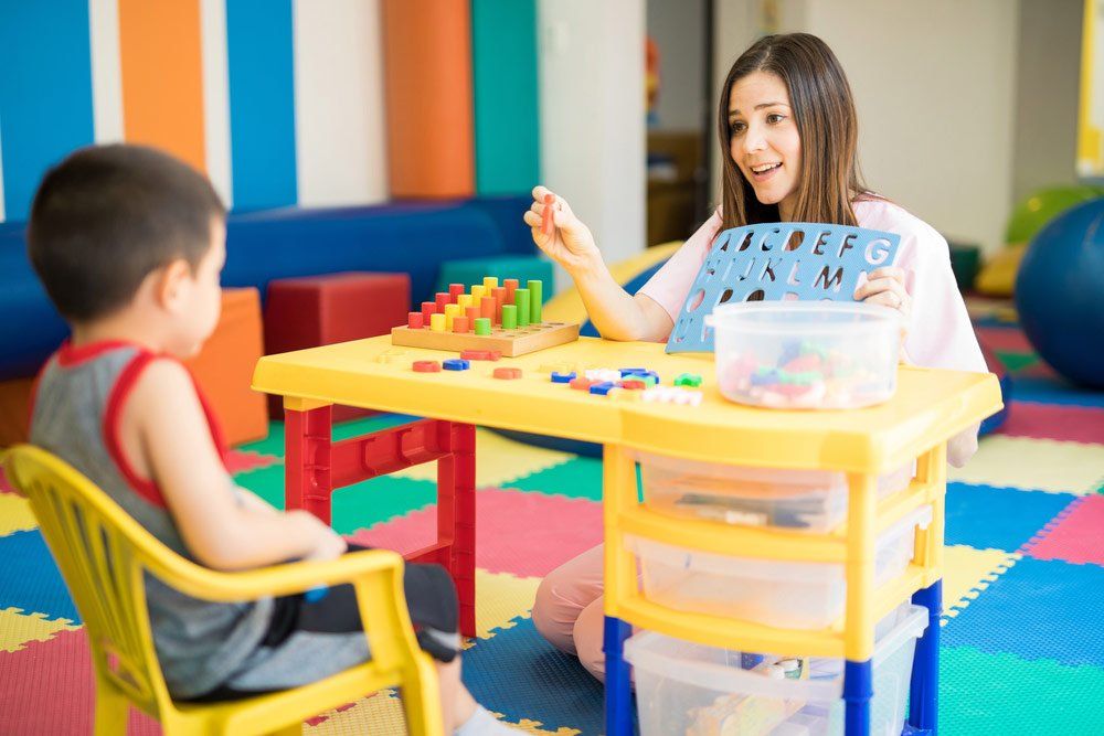 Language Therapist Teaching a Kid — Better Access Support Services In Wyreema, QLD