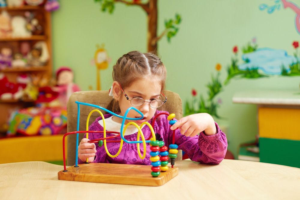 A Cute Little Girl Playing With Developing Toy