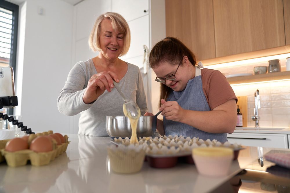 Support Coordinator With Young Adult In The Kitchen
