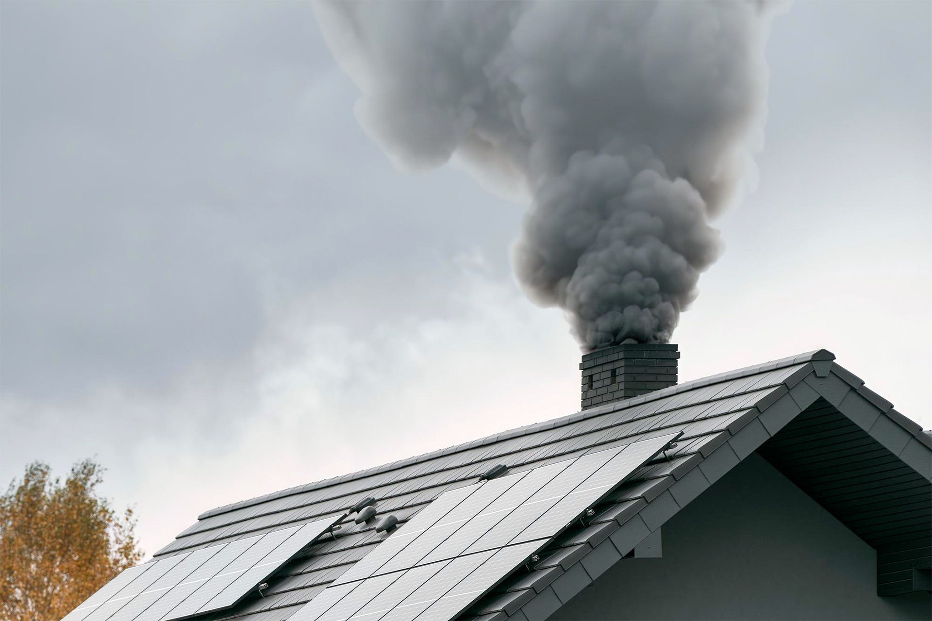 Smoke rising from a KY home chimney showing chimney fire warning signs and fireplace safety concerns