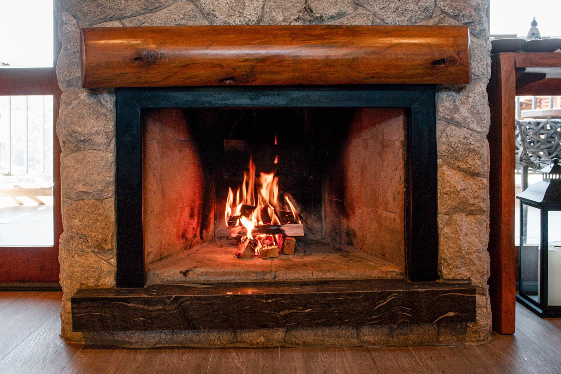 Wood burning fireplace insert in a Kentucky home with masonry hearth, flue liner, glass and surround