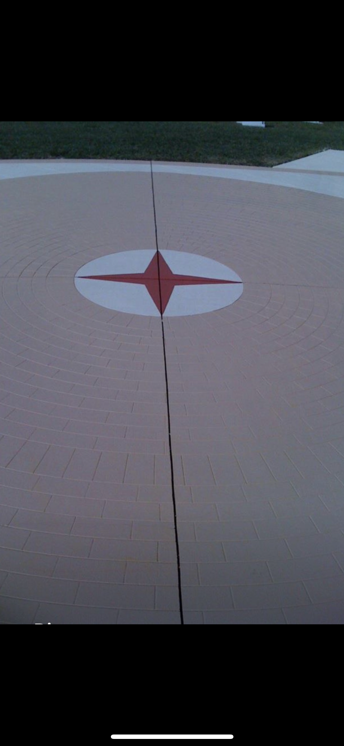 A painted star on a beige surface with a black line running through it.