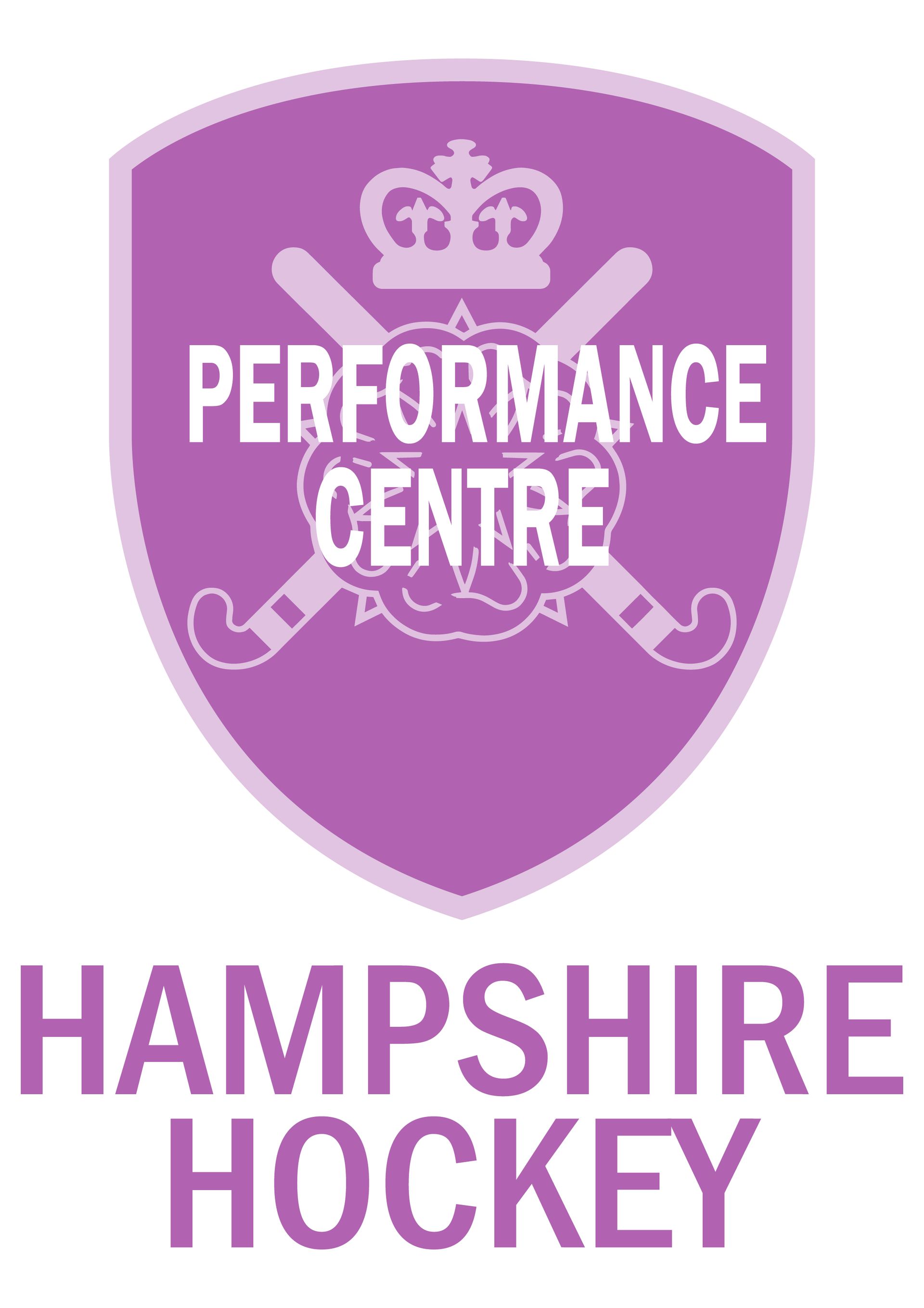 The logo for hampshire hockey is a purple shield with crossed hockey sticks and a crown.