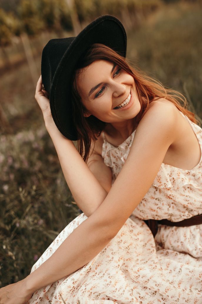 happy woman wearing a black hat