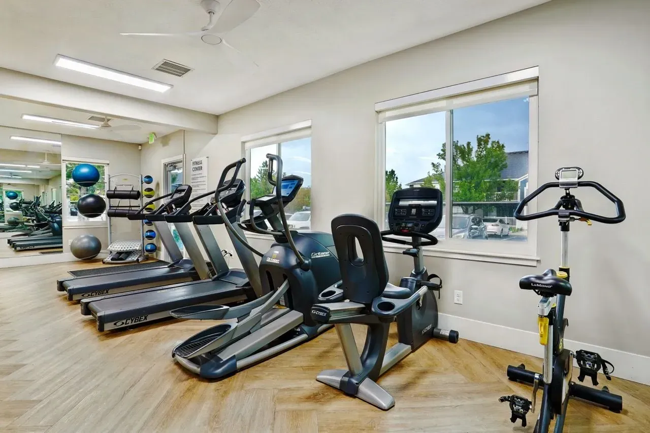 Fitness center with treadmills, elliptical machines, and stationary bikes.
