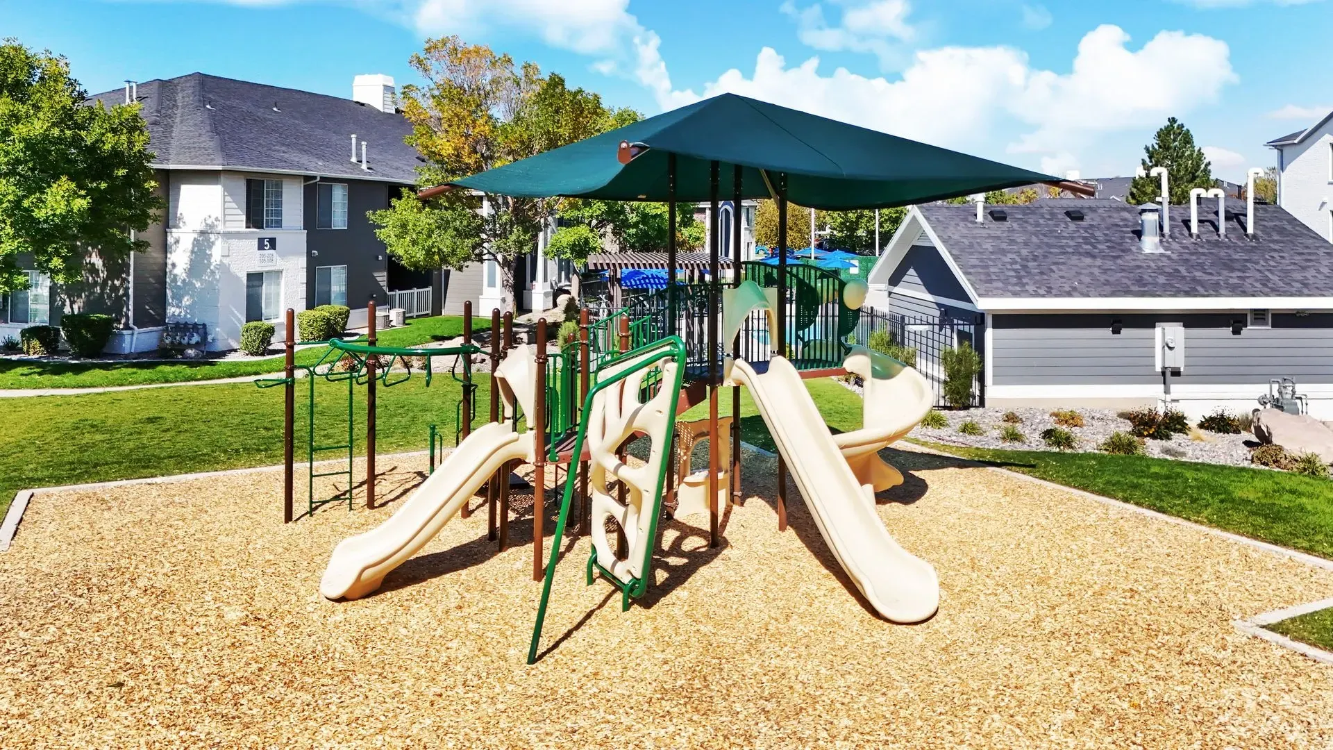 Playground equipment with slides and climbing structures.