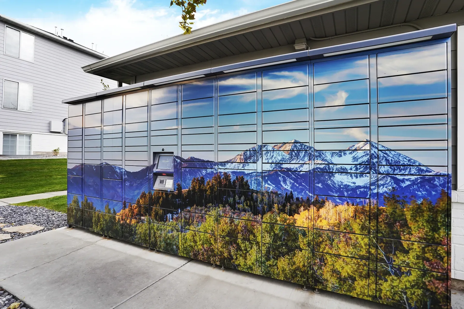Parcel locker with a mountain landscape wrap at Woodgate in West Jordan, UT.