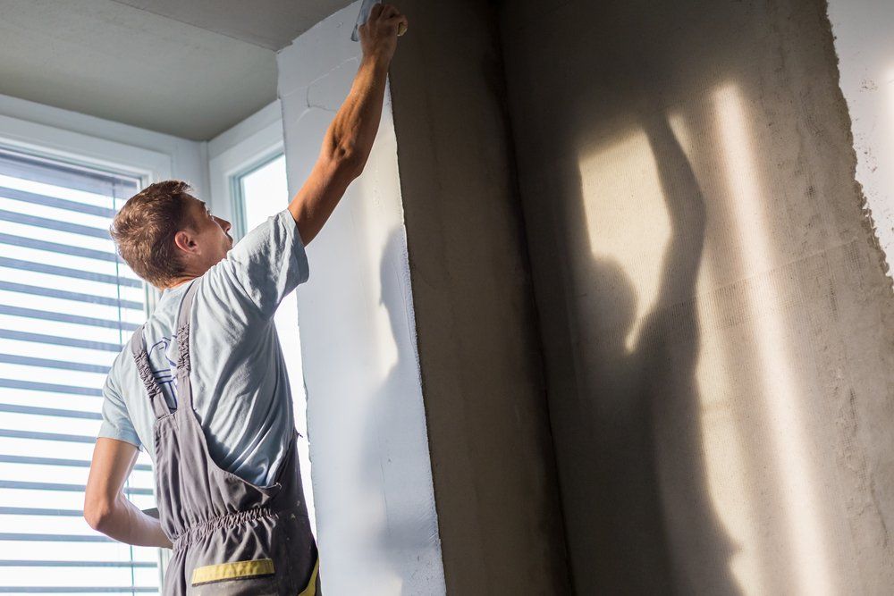 Man Plastering the Room— East Coast Cement Rendering in Lismore, NSW