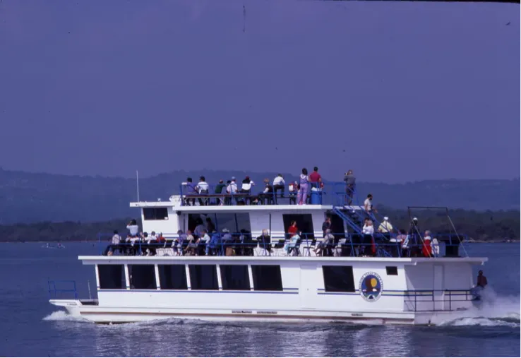Passenger ferry crowded with people cruising on calm blue water under a clear sky