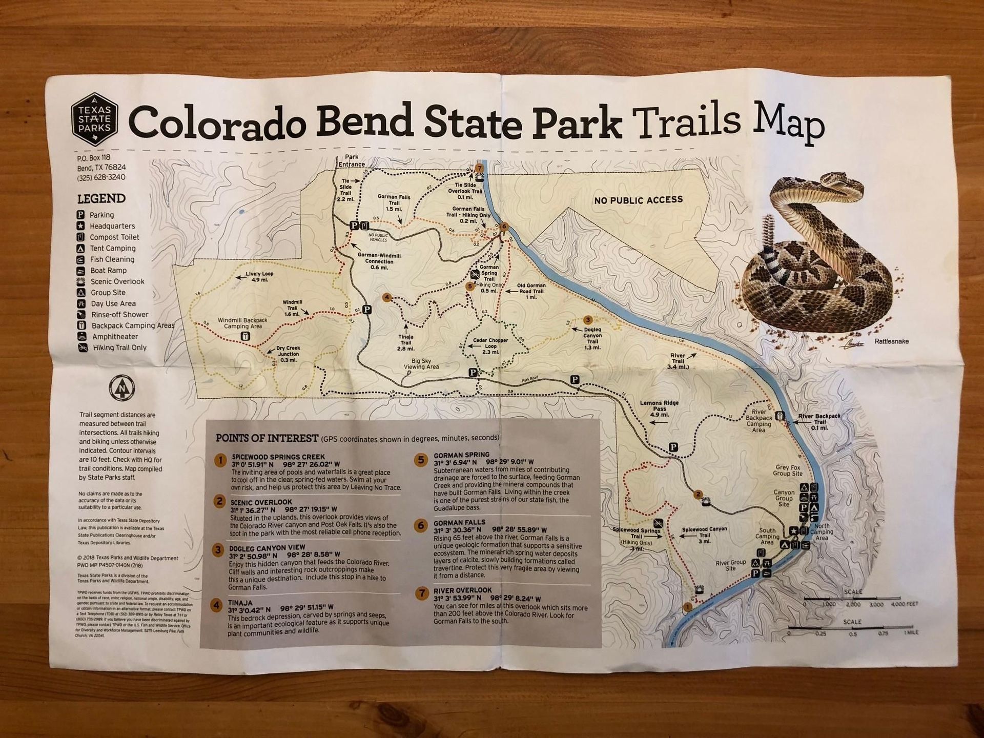 Colorado Bend State Park trails map on tan paper, showing trails, lake, and route details.