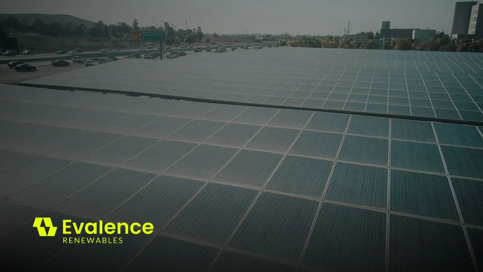 Solar panels in a large array under a blue sky, with the Evalence logo in the corner.