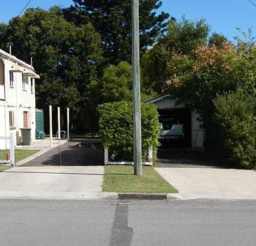 A House With A Garage And A Driveway — Roll Formed Driveways in Yandina, QLD