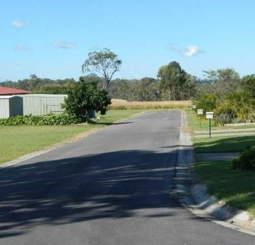A Road with a lot of Grass on the side of it — Roll Formed Driveways in Yandina, QLD