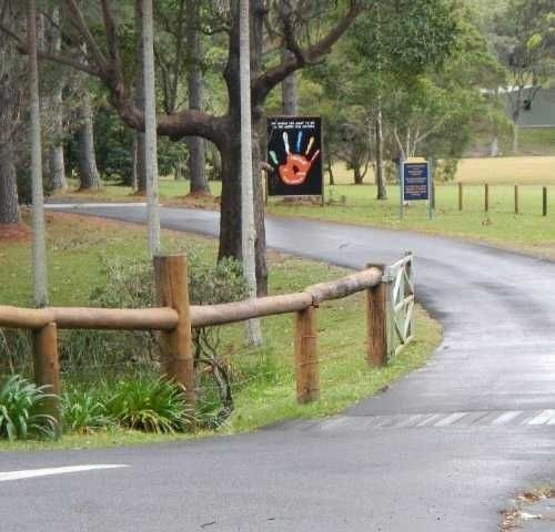 A Road with A Fence and A Sign — Roll Formed Driveways in Yandina, QLD