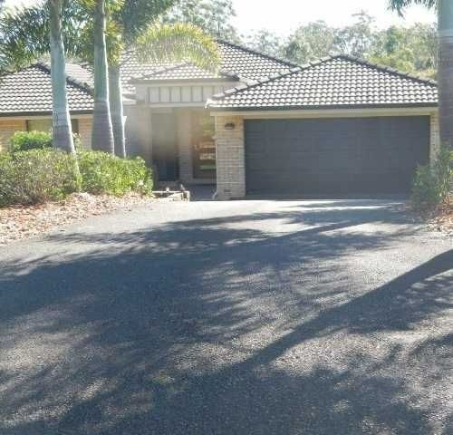 A House With A Driveway and Trees — Roll Formed Driveways in Yandina, QLD