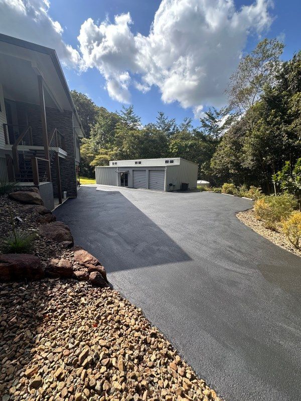 A Driveway Leading To A House With A Garage In The Background — Roll Formed Driveways in Kingaroy, QLD