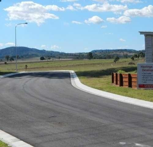 A Road with a Sign that says Prestige Development on it — Roll Formed Driveways in Yandina, QLD