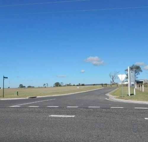 A Newly Paved Road With Road Signage — Roll Formed Driveways in Yandina, QLD