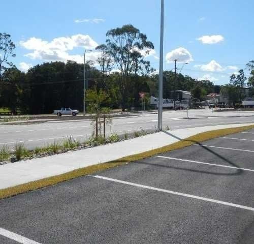 A Parking Lot with A Sidewalk and A Street — Roll Formed Driveways in Yandina, QLD